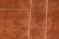 Clay red tennis court and yellow tennis ball flying over it during game or training. Athletic field, Sports background Royalty Free Stock Photo