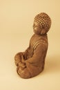 Buddha statue sitting down with legs crossed in prayer