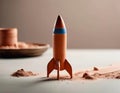 Clay Rocket Model on Reddish Powder SurfaceâArtisanal Craft Scene with Warm Lighting Royalty Free Stock Photo
