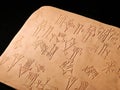 Clay tablet engraved with cuneiform script, ancient mesopotamian writing system artifact with sumerian and akkadian characters, Royalty Free Stock Photo