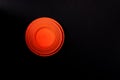 Clay target for skeet shooting against the black background