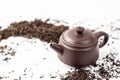 Clay tea pot and black tea on white background close up, Chinese tea ceremony Royalty Free Stock Photo