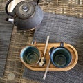 clay teapot with brewing Chinese tea, ceramic cup and wooden plate on the table in the kitchen or cafe Royalty Free Stock Photo