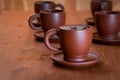 Clay teapot and cups on table Royalty Free Stock Photo