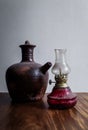 Clay water jug and traditional oil lamp Royalty Free Stock Photo