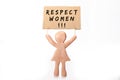 clay woman figurine holding respect for women protest banner