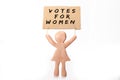 clay woman figurine holding voters for women protest banner