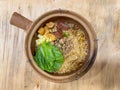 Rice cooked inside hot claypot with crispy pork belly, minced meat, tofu and soup Royalty Free Stock Photo