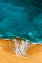 Clean beach with beautiful yellow sand and turquoise sea, vertical photo. Beautiful seascape, view from the height. Royalty Free Stock Photo