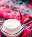 Sensitive skincare moisturizer cream on flower petals and water background, natural science for skin Royalty Free Stock Photo