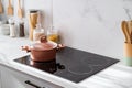 Clean black induction stove with control panel near marble countertop Royalty Free Stock Photo