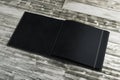 Clean black notepad on wooden desktop