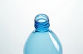 Clean blue plastic bottle neck shows threads for cap closure. Empty container on white surface, ready for recycling or reuse. Royalty Free Stock Photo