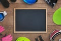 Clean chalkboard surrounded by ski equipemnt on wooden table Royalty Free Stock Photo