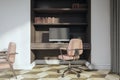 Clean classic home office interior with wooden bookcase, furniture and workplace.