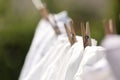 Clean clothes drying outdoors, closeup. Focus on clothespin Royalty Free Stock Photo