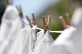Clean clothes drying outdoors, closeup. Focus on clothespin Royalty Free Stock Photo