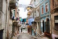 Clean clothes drying on a rope between old houses of narrow street