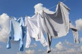 Clean clothes hanging on washing line against sky. Drying laundry Royalty Free Stock Photo