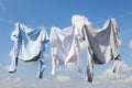 Clean clothes hanging on washing line against sky. Drying laundry Royalty Free Stock Photo