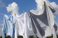 Clean clothes hanging on washing line against sky. Drying laundry Royalty Free Stock Photo