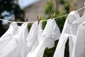 Clean clothes hanging on washing line in garden. Drying laundry Royalty Free Stock Photo