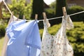 Clean clothes hanging on washing line in garden. Drying laundry Royalty Free Stock Photo