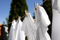 Clean clothes hanging on washing line in garden. Drying laundry Royalty Free Stock Photo