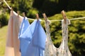 Clean clothes hanging on washing line in garden. Drying laundry Royalty Free Stock Photo