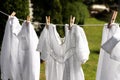 Clean clothes hanging on washing line in garden. Drying laundry Royalty Free Stock Photo