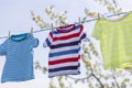 Clean clothes on rope outdoors on laundry day. Colorful t-shirts hanging on a laundry line against blue sky Royalty Free Stock Photo