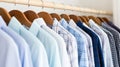 Clean clothes white and blue men\'s shirts on hangers after dry-cleaning or for sale in the shop