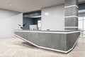 Clean concrete and hardwood office interior with reception desk and window with city view. Office lobby and waiting area concept. Royalty Free Stock Photo