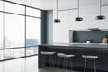 Clean concrete kitchen interior with panoramic city view, furniture and reflections on floor. Luxury living concept.