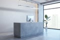 Clean concrete office reception desk and panoramic window with city view. Workplace concept.