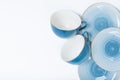 Clean dishes, coffee or tea set. Plenty of elegant porcelain cups and saucers at white