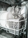 Clean dishes and cutlery in the dishwasher. Cleaning and cleanliness concept