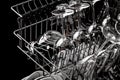 Clean dishes in the dishwasher. Wine glasses, sparkling wine glasses. Close-up. Washing-up and housework concept Royalty Free Stock Photo