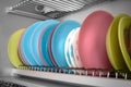 Clean dishes drying on metal racks for dishes on the shelves. Storing clean kitchen utensils and drying them Royalty Free Stock Photo