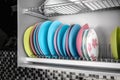 Clean dishes drying on metal racks for dishes on the shelves. Storing clean kitchen utensils and drying them Royalty Free Stock Photo