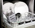 Clean dishes, glasses and cutlery in a dishwasher