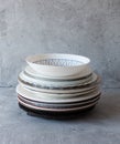 Clean dishes on the table in a stack on a gray background