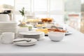 Clean dishware and different meals for breakfast on white table indoors. Buffet service Royalty Free Stock Photo