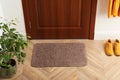 Clean door mat on wooden floor in hall, above view Royalty Free Stock Photo