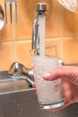 Clean drinking water is poured from the kitchen tap Royalty Free Stock Photo