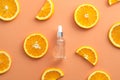 Clean dropper bottle Vitamin C extract and sliced orange top view