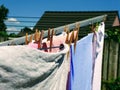Clean drying clothing on dry rack in garden. Royalty Free Stock Photo