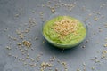 Clean eating and detox concept. Green vegan smoothie in bowl. Sprouted seeds around. Healthy green organic raw dish for Royalty Free Stock Photo