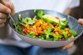 Clean eating, vegan healthy salad bowl closeup , woman holding salad bowl, plant based healthy diet with greens, salad, chickpeas Royalty Free Stock Photo