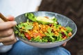 Clean eating, vegan healthy salad bowl closeup , woman holding salad bowl, plant based healthy diet with greens, salad, chickpeas Royalty Free Stock Photo